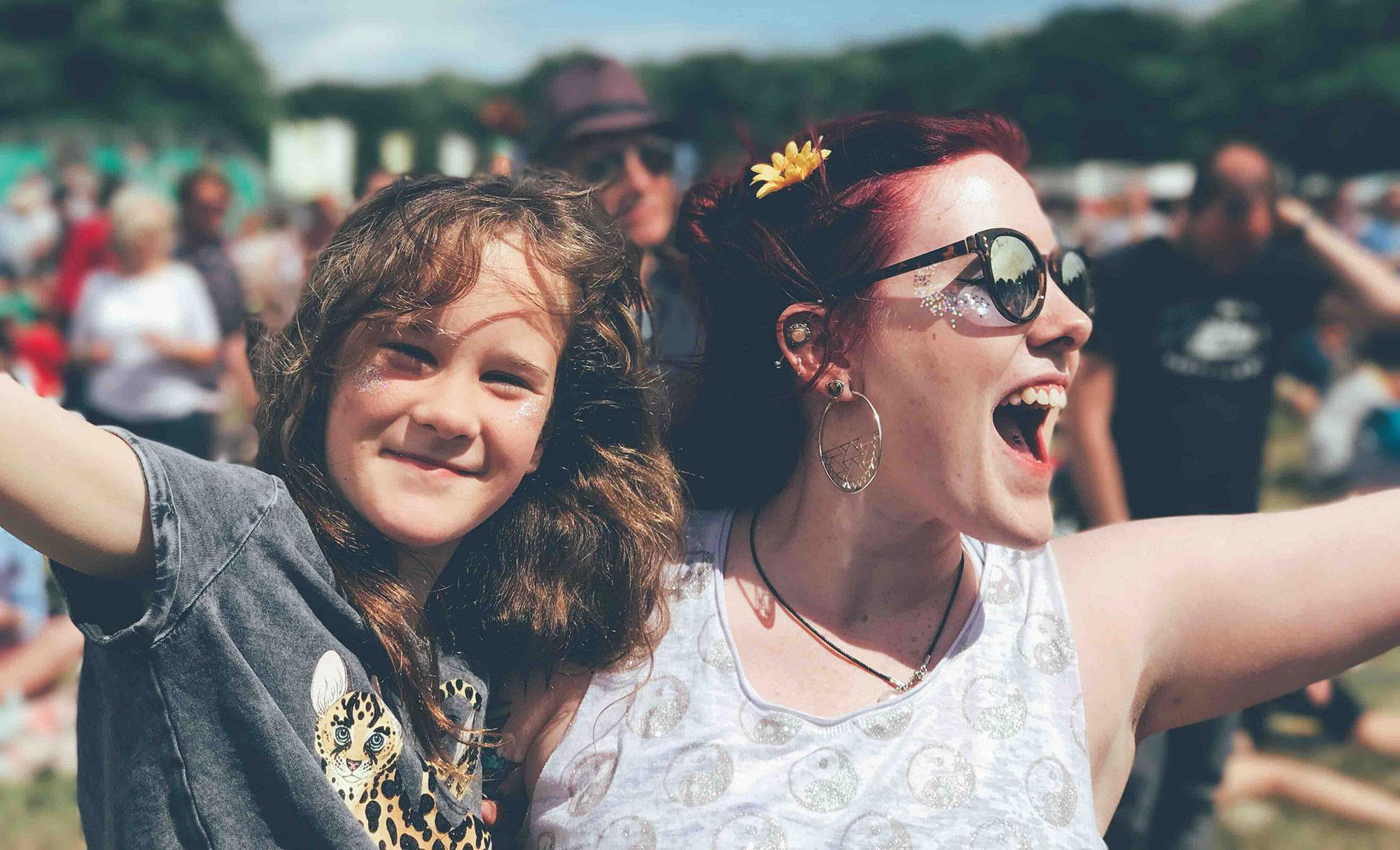 a girl and a woman at a festival
