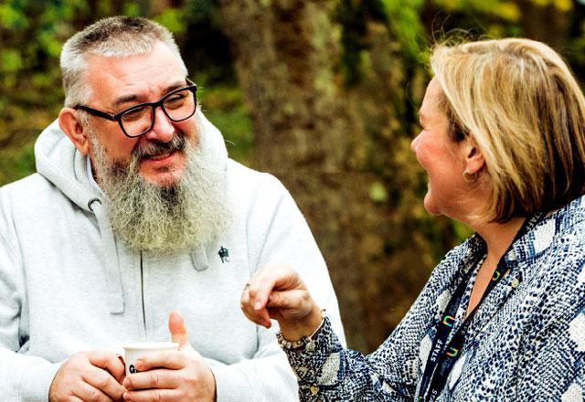 Two people talking and smiling